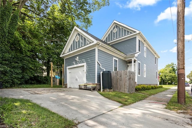 401 W 30th St, Norfolk, VA 23508 - view of home's exterior featuring a garage, board and batten siding, and driveway