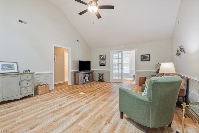 633 Aguila Dr, Chesapeake, VA 23322 - living room with high vaulted ceiling, wainscoting, light wood-style flooring, and ceiling fan