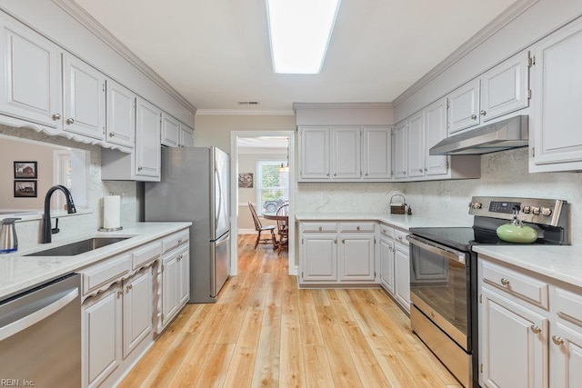 633 Aguila Dr, Chesapeake, VA 23322 - kitchen with appliances with stainless steel finishes, under cabinet range hood, light wood-style floors, backsplash, and crown molding