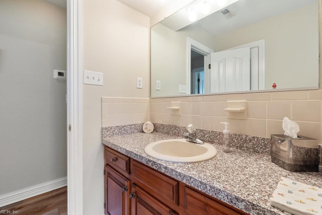 633 Aguila Dr, Chesapeake, VA 23322 - bathroom with vanity, tasteful backsplash, and wood finished floors