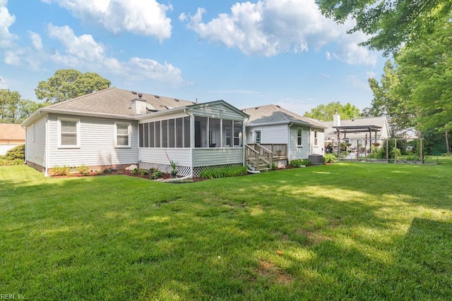 633 Aguila Dr, Chesapeake, VA 23322 - back of property with a sunroom, a yard, and a shingled roof
