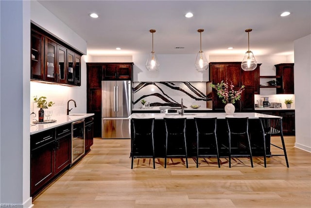 3 Menife Ct, Williamsburg, VA 23188 - kitchen featuring freestanding refrigerator, light countertops, tasteful backsplash, a breakfast bar area, and recessed lighting