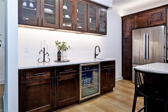 3 Menife Ct, Williamsburg, VA 23188 - bar featuring high end fridge, wine cooler, backsplash, and light wood-style flooring