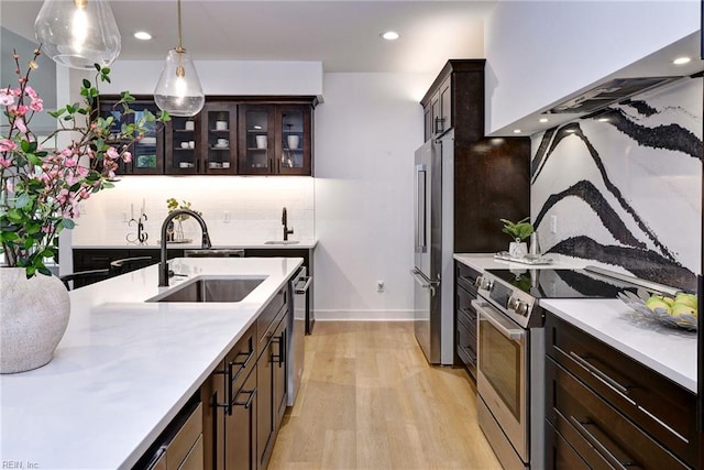 3 Menife Ct, Williamsburg, VA 23188 - kitchen with stainless steel appliances, light wood-style flooring, light countertops, dark brown cabinets, and recessed lighting