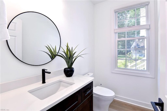 3 Menife Ct, Williamsburg, VA 23188 - half bath featuring plenty of natural light, vanity, and wood finished floors
