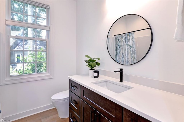 3 Menife Ct, Williamsburg, VA 23188 - full bath featuring vanity, plenty of natural light, wood finished floors, and a shower with curtain