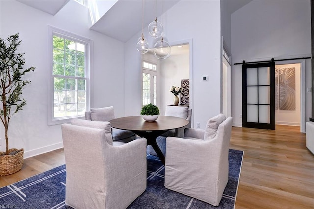 3 Menife Ct, Williamsburg, VA 23188 - dining space with wood finished floors, high vaulted ceiling, and a barn door