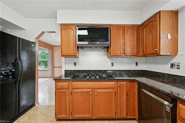 700 Hilltop Ct, Chesapeake, VA 23322 - kitchen featuring black appliances, dark stone counters, tasteful backsplash, and brown cabinetry
