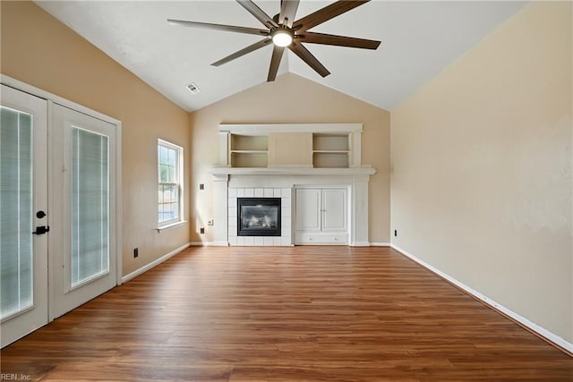 700 Hilltop Ct, Chesapeake, VA 23322 - unfurnished living room with a ceiling fan, a tile fireplace, wood finished floors, vaulted ceiling, and built in features