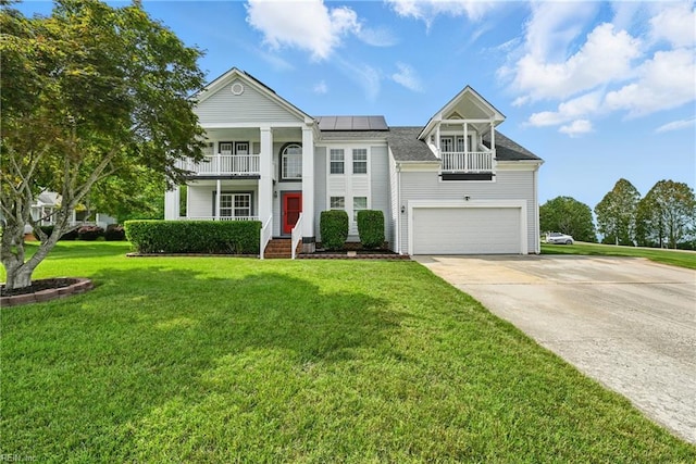 700 Hilltop Ct, Chesapeake, VA 23322 - neoclassical home featuring a balcony, solar panels, concrete driveway, and an attached garage