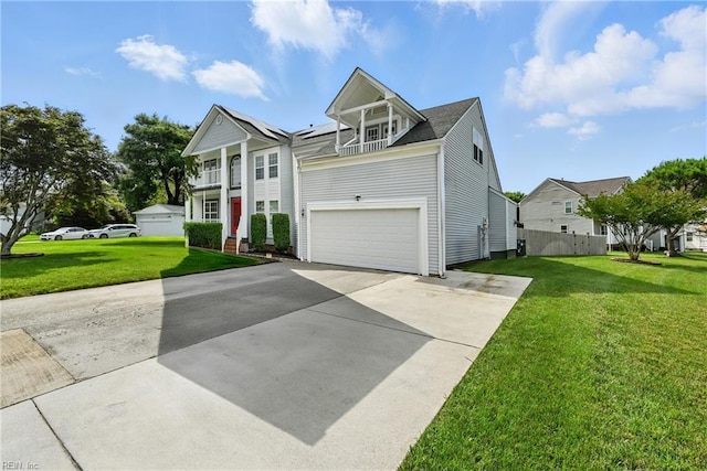 700 Hilltop Ct, Chesapeake, VA 23322 - neoclassical home with a front lawn, concrete driveway, an attached garage, and solar panels