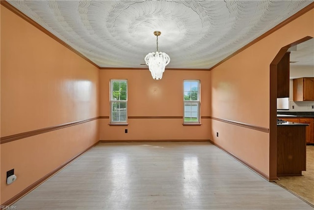 700 Hilltop Ct, Chesapeake, VA 23322 - unfurnished dining area featuring ornamental molding, light wood-type flooring, a chandelier, and arched walkways