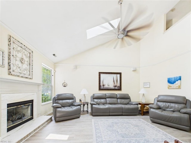 2909 Drum Point Cres, Chesapeake, VA 23321 - living room with wood finished floors, ceiling fan, a fireplace, a skylight, and high vaulted ceiling