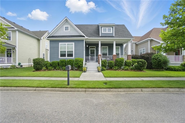 3216 Meanley Dr, Chesapeake, VA 23323 - craftsman-style house featuring covered porch, a front lawn, and a shingled roof