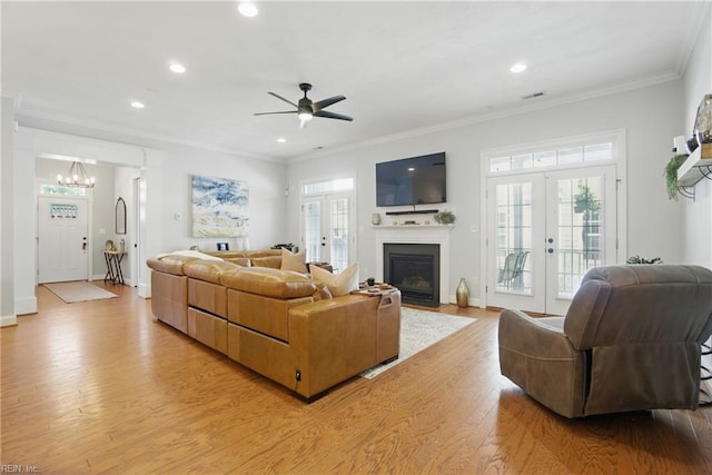 3216 Meanley Dr, Chesapeake, VA 23323 - living area with french doors, light wood-style flooring, a ceiling fan, a fireplace with flush hearth, and recessed lighting