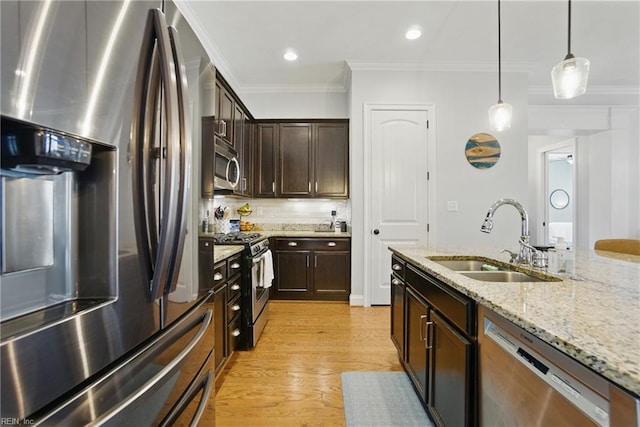 3216 Meanley Dr, Chesapeake, VA 23323 - kitchen featuring appliances with stainless steel finishes, crown molding, dark brown cabinets, decorative light fixtures, and light stone countertops