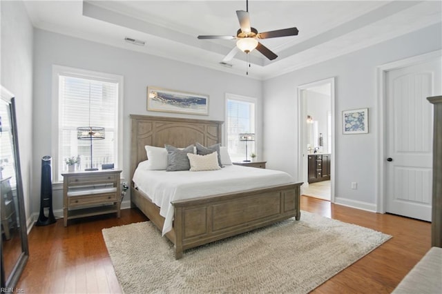 3216 Meanley Dr, Chesapeake, VA 23323 - bedroom featuring a tray ceiling, ornamental molding, wood finished floors, connected bathroom, and ceiling fan