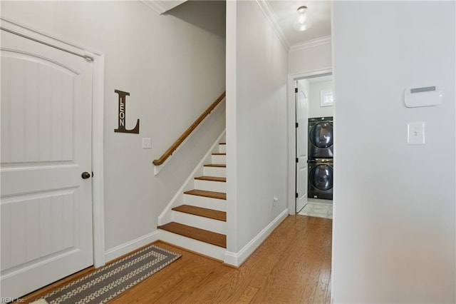 3216 Meanley Dr, Chesapeake, VA 23323 - stairs featuring wood finished floors, ornamental molding, and stacked washer and clothes dryer
