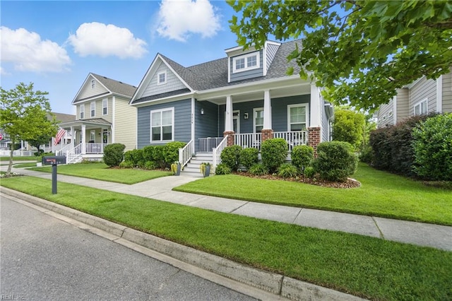 3216 Meanley Dr, Chesapeake, VA 23323 - view of front facade with covered porch, a front yard, and roof with shingles