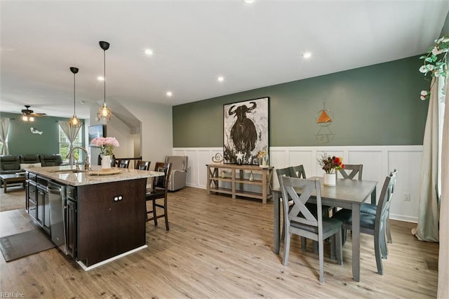 112 Mccormick Pl, Williamsburg, VA 23185 - kitchen with open floor plan, a decorative wall, dishwasher, a breakfast bar area, and a center island with sink