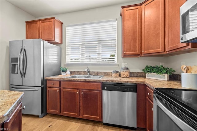 616 Foster Ln, Virginia Beach, VA 23451 - kitchen with stainless steel appliances, light wood-style flooring, light countertops, and brown cabinetry