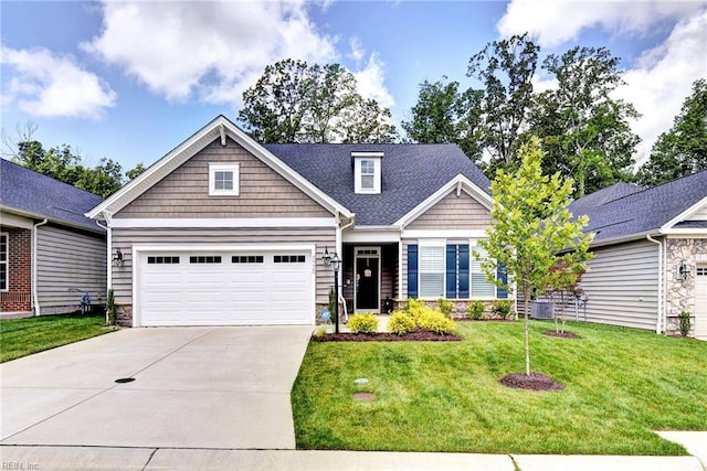3998 Isaac Cir, Williamsburg, VA 23188 - craftsman-style home with concrete driveway, a front yard, an attached garage, and stone siding
