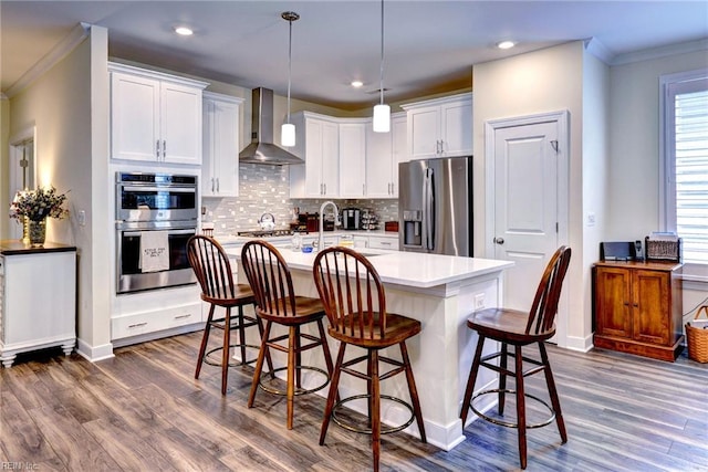 3998 Isaac Cir, Williamsburg, VA 23188 - kitchen with stainless steel appliances, wall chimney range hood, crown molding, dark wood-style flooring, and tasteful backsplash