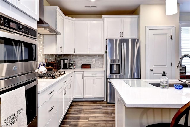 3998 Isaac Cir, Williamsburg, VA 23188 - kitchen with appliances with stainless steel finishes, light countertops, white cabinetry, and dark wood-style floors