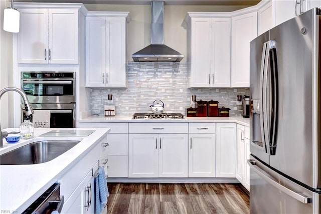 3998 Isaac Cir, Williamsburg, VA 23188 - kitchen with stainless steel appliances, wall chimney exhaust hood, white cabinetry, light countertops, and dark wood-style flooring