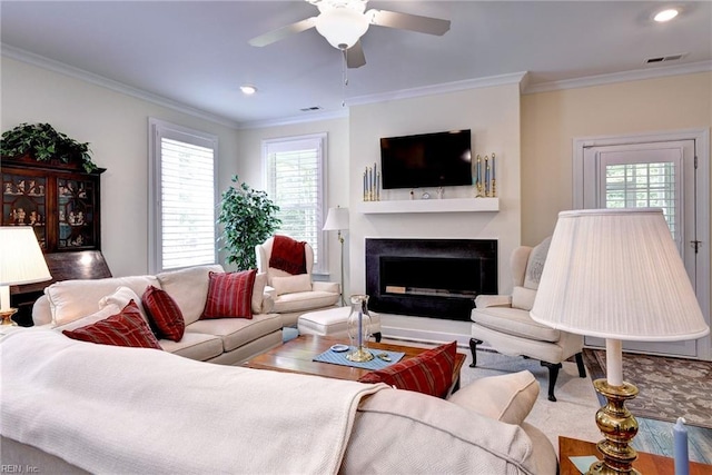 3998 Isaac Cir, Williamsburg, VA 23188 - living room with plenty of natural light, a fireplace, crown molding, a ceiling fan, and recessed lighting