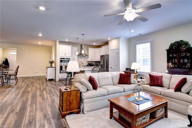 3998 Isaac Cir, Williamsburg, VA 23188 - living room with ornamental molding, dark wood finished floors, ceiling fan, and recessed lighting