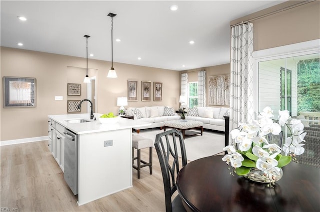 105 Repose Rd, Williamsburg, VA 23185 - kitchen with stainless steel dishwasher, light wood-style flooring, light countertops, a center island with sink, and recessed lighting