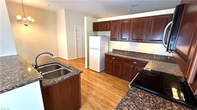 450 W Princess Anne Rd Unit 208, Norfolk, VA 23517 - kitchen featuring freestanding refrigerator, light wood-style floors, a chandelier, range with electric stovetop, and decorative light fixtures