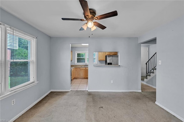 6625 Stoney Pt, Norfolk, VA 23502 - unfurnished living room featuring a ceiling fan, light colored carpet, and stairway