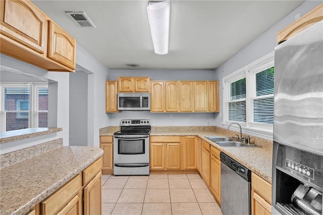 6625 Stoney Pt, Norfolk, VA 23502 - kitchen featuring stainless steel appliances, light brown cabinets, light countertops, and light tile patterned floors
