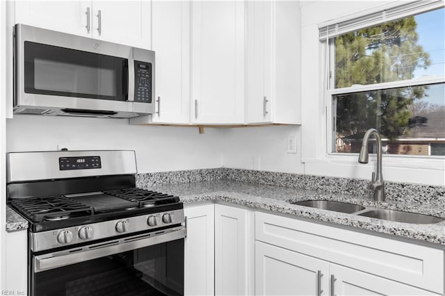 2850 Grandy Ave, Norfolk, VA 23509 - kitchen with stainless steel appliances, white cabinetry, and light stone countertops