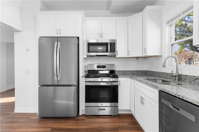 2850 Grandy Ave, Norfolk, VA 23509 - kitchen featuring appliances with stainless steel finishes, light stone counters, white cabinetry, and dark wood-style floors