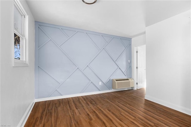 2850 Grandy Ave, Norfolk, VA 23509 - unfurnished room featuring a wall unit AC, wood finished floors, and a decorative wall