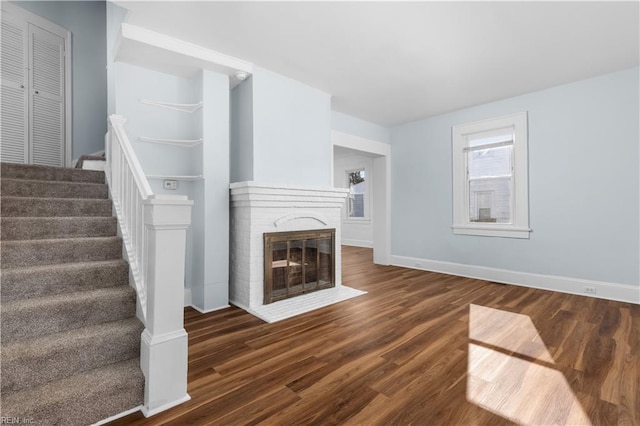 2850 Grandy Ave, Norfolk, VA 23509 - unfurnished living room featuring stairway, wood finished floors, and a fireplace