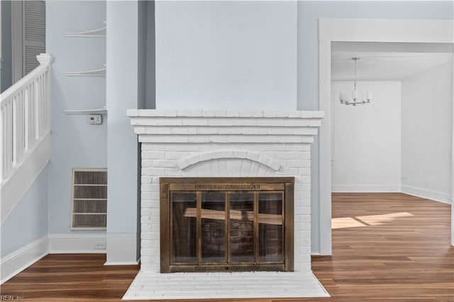 2850 Grandy Ave, Norfolk, VA 23509 - detailed view of wood finished floors, a brick fireplace, and a chandelier
