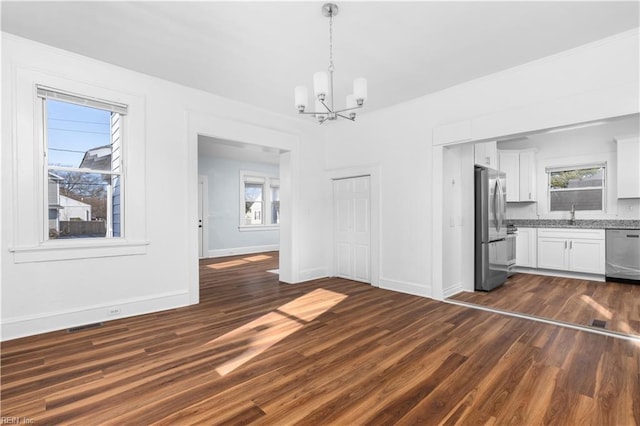 2850 Grandy Ave, Norfolk, VA 23509 - unfurnished dining area with a chandelier and dark wood-style floors