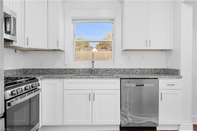 2850 Grandy Ave, Norfolk, VA 23509 - kitchen featuring appliances with stainless steel finishes, light stone countertops, and white cabinets