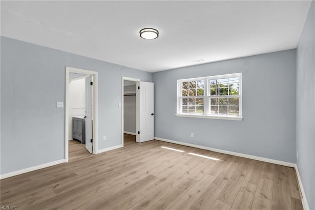 3 Maume Cir, Hampton, VA 23666 - unfurnished bedroom with wood finished floors, a spacious closet, ensuite bath, and a closet