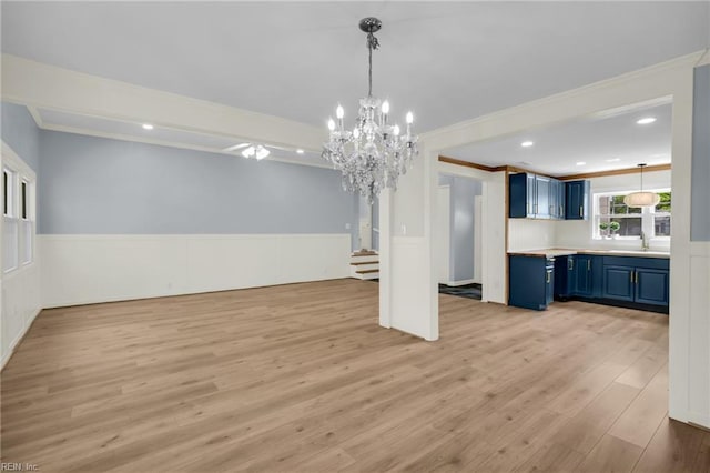 3 Maume Cir, Hampton, VA 23666 - unfurnished living room featuring crown molding, light wood-style flooring, a wainscoted wall, a chandelier, and stairway