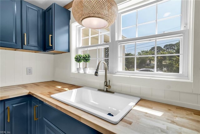 3 Maume Cir, Hampton, VA 23666 - kitchen featuring blue cabinetry, wooden counters, and wood finished floors