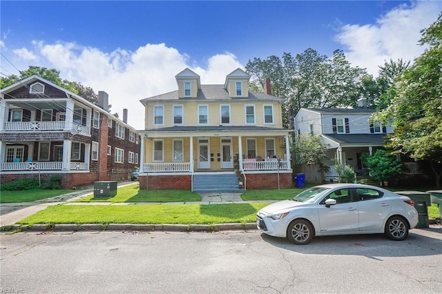 1439 Moultrie Ave, Norfolk, VA 23509 - view of front of home featuring covered porch, a front yard, and a chimney