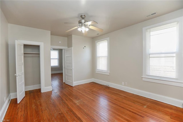 1439 Moultrie Ave, Norfolk, VA 23509 - unfurnished bedroom featuring hardwood / wood-style flooring, multiple windows, a closet, and ceiling fan