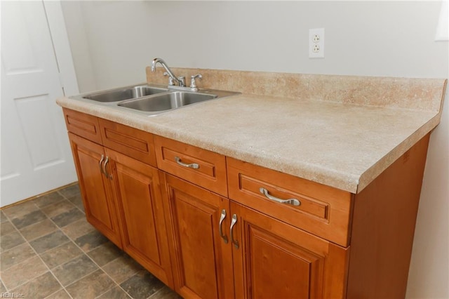 1439 Moultrie Ave, Norfolk, VA 23509 - kitchen featuring brown cabinetry, light countertops, and stone finish flooring