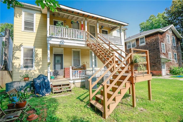 1439 Moultrie Ave, Norfolk, VA 23509 - back of property with covered porch, stairway, and a lawn