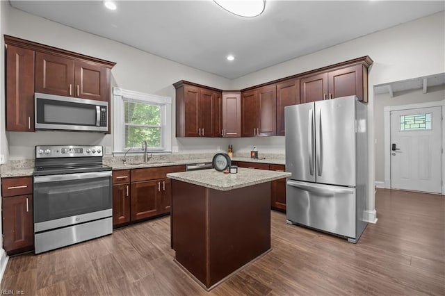 256 Lee St, Hampton, VA 23669 - kitchen featuring stainless steel appliances, wood finished floors, recessed lighting, light stone countertops, and a kitchen island